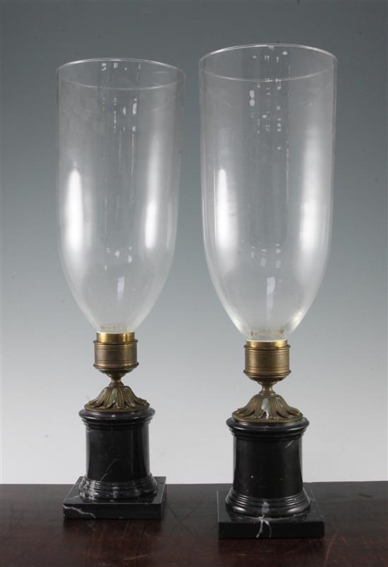 A pair of marble based storm lamps, 19.5in.
